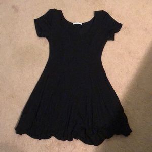 Short fitted black dress with scoop neckline